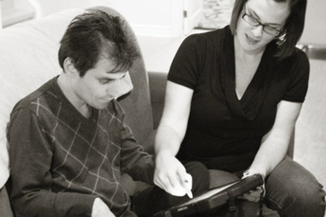John and an Intervenor using Facilitated Typing (CNW Group/DeafBlind Ontario Services)