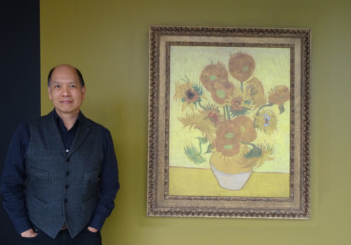 Vancouver art gallery owner Ian Tan admires Van Gogh "Sunflower" painting.