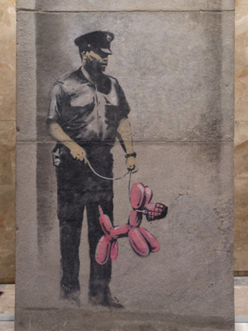 This is an image of the Banksy piece, comprised of three pieces of concrete that were reassembled and are now installed in the PATH network at One York Street. (Image supplied by Menkes Developments; Photo by Paul Casselman) (CNW Group/Menkes Developments Ltd.)