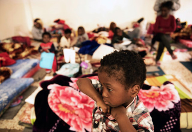 A child stands in a room where women and children sleep on old mattresses laid on the floor at a detention centre, in Libya. Sixty women, 20 children and 115 men were being held at the detention centre when UNICEF visited on January 29, 2017. Conditions at the centre are poor, with dozens of people crowded into small spaces. One child interviewed said they are only taken outside once every four days. © UNICEF/UN052793/Romenzi (CNW Group/UNICEF Canada)