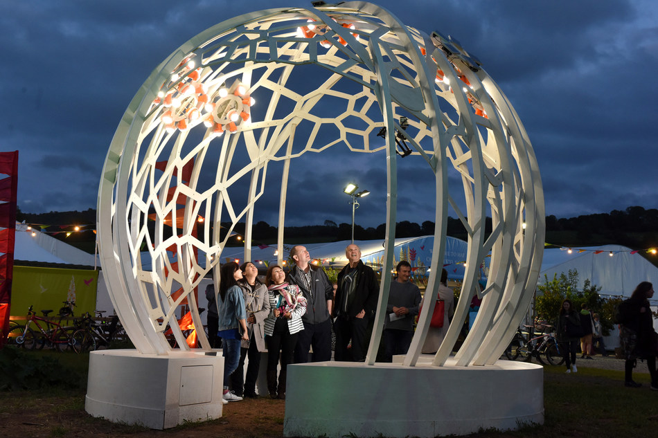 Hay Festival goers admire the 'Night Time Sun', an interactive art installation inspired by Jaguar Land Rover’s ‘Lighting up Lives’ solar project in Kenya (PRNewsfoto/Jaguar Land Rover)