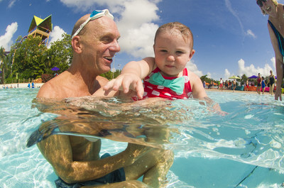 Rowdy Gaines, 3-time Olympic Gold Medalist and event spokesperson, works with a young swimmer at the World's Largest Swimming Lesson at Seaworld's Aquatica Waterpark in Orlando. The park was one of more than 600 locations in 27 countries around the globe that participated in today's event to help spread the word Swimming Lessons Save Lives.