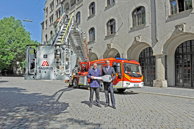 Symbolic key handover infront of a new vehicle: (from left to right) Wolfgang Schäuble, Head of municipal fire brigade Munich and Marc Diening, CEO Magirus (Copyright: Magirus) (PRNewsfoto/Magirus)