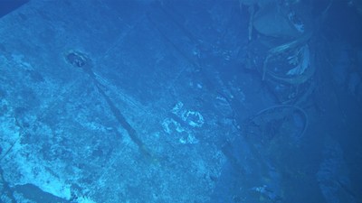 An image shot from a remotely operated vehicle shows what appears to be the painted hull number "35." Based on the curvature of the hull section, this seems to be the port side of the ship.?Photo courtesy of Paul G. Allen