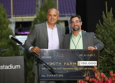 Dimitrios Smyrnios, CEO of Schwan's Company announces a new charitable partnership with Minnesota-based non-profit Youth Farm. Smyrnios presents Gunnar Liden of Youth Farm a $150,000 financial donation from Schwan's Corporate Giving Foundation at U.S. Bank Stadium on Thursday, Sept. 14, 2017, in Minneapolis. (Andy Clayton-King/AP Images for Schwan's Company)