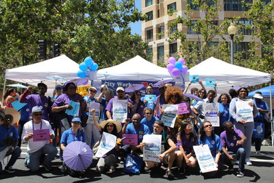 City of Oakland workers smile for a photo at the Art and Soul festival in Downtown Oakland.