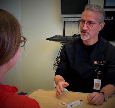 Peter Schultz, MD, Nura trains a patient on the use of Narcan.