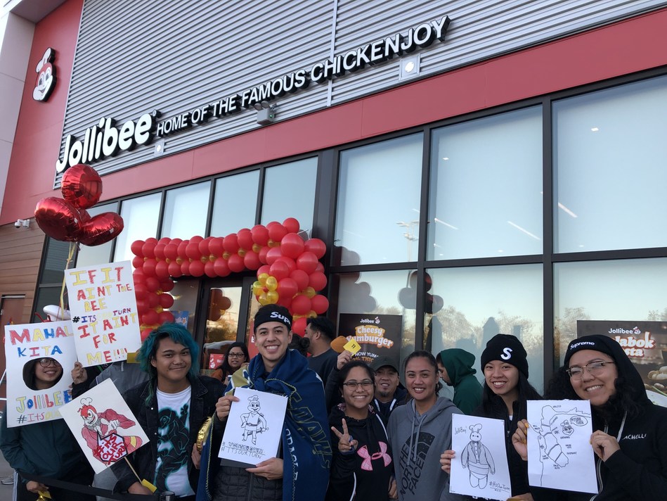 Fans with #ItsOurTurn signs eagerly wait outside of the Jollibee Hayward store on Saturday, September 21 in anticipation for the official opening. (Photo credit: Jollibee)