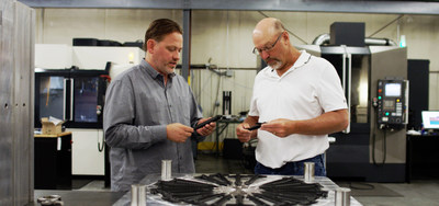 Allegiance Mold President and CEO Ted Stender and senior mold designer Dave VanDeLaare inspecting final parts from plastic injection mold designed and manufactured using Cimatron