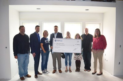 PenFed Credit Union employees present a $4,000 donation check to White Bird Clinic staff at their new dental clinic construction site at 1415 Pearl Street, Eugene, Oregon.