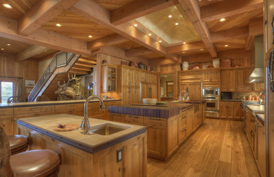 Designed in the style of the most exclusive luxury mountain resorts, the home boasts impeccable construction and interiors with fine finishes like reclaimed Douglas fir. The gourmet kitchen (shown here) includes top-of-the-line appliances, several prep sinks, and an immense kitchen island with wooden butcher block tops. DurangoLuxuryAuction.com.