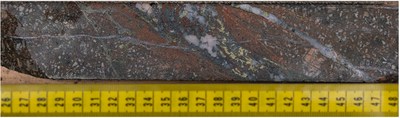 Figure 3: Photo taken of stock-work hosted and disseminated chalcopyrite-bornite within potassic alteration assemblage of secondary K-feldspar and 