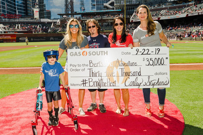 Cleo “Link,” Kristin Klingshirn and Molly Darby accepted the check from Gas South's Carley Stephens at the Atlanta Braves game on September 22. (Photo by is Kevin D. Liles)