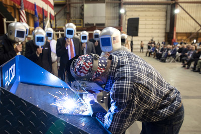 A welder authenticates the keel of LCS 27, the future USS Nantucket, by welding the initials of ship sponsor Polly Spencer.