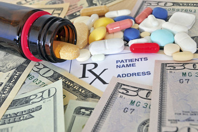 Close up photo of prescription pills and money