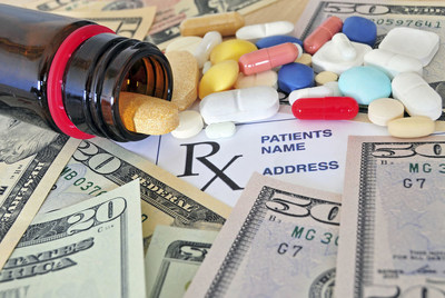 Close up photo of prescription pills and money Close up photo of prescription pills and money