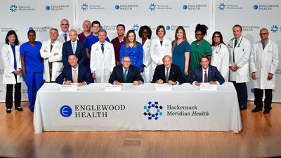 Warren Geller, president and CEO, Englewood Health; Thomas C. Senter, Esq., chairman, Board of Trustees, Englewood Health; Gordon N. Litwin, Esq., chairman, Board of Trustees, Hackensack MeridianHealth; and Robert C. Garrett, FACHE, CEO, Hackensack Meridian Health. The two health care systems have signed a definitive agreement to merge. Also pictured are physicians, nurses, and other clinical staff from Englewood Health and Hackensack MeridianHealth.