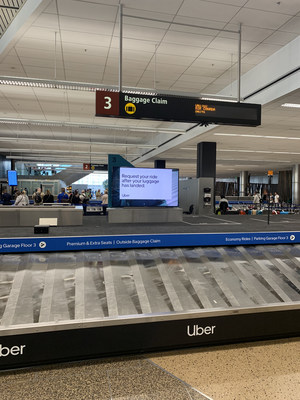 Digital signage at baggage claim reminds Sea-Tac travelers their ride is just a click away.