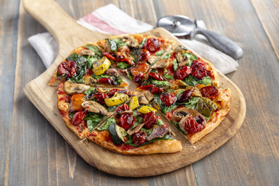 Vegan Garden Pizza from the UNO Love All, Feed All menu. Hand-stretched thin crust pizza dough topped with housemade pizza sauce, fresh spinach, roasted vegetables, mushrooms and dorati cherry tomatoes.