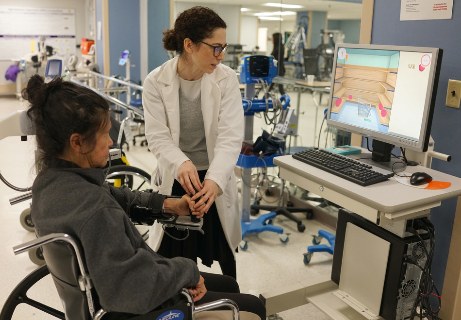 Occupational therapist Heather Wesson assists a stroke rehabilitation patient at NYU Langone Hospital–Brooklyn.