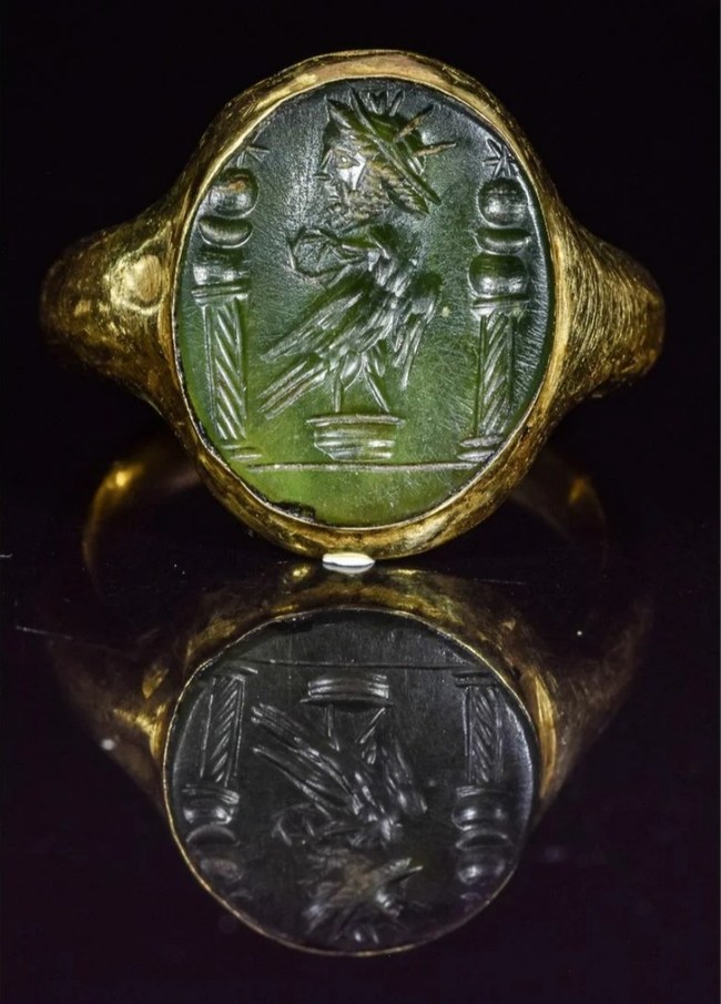 Roman gold and jasper                          intaglio ring, circa 200 A.D., with depiction of                          eagle, laurel wreath, crowned head of the sun                          god Salus, and two columns, each supporting a                          sun, moon and star. Estimate: £2,000-£3,000
