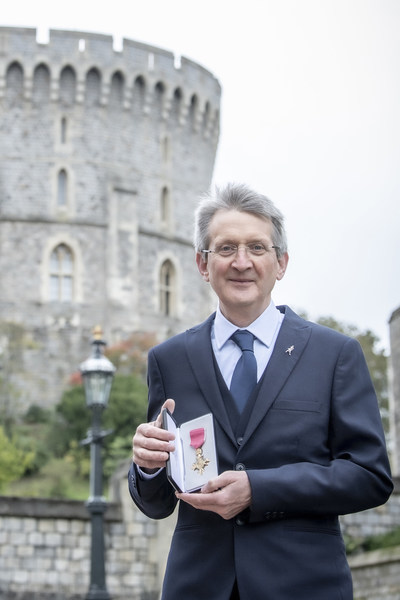 Dr. Jim Beveridge with his OBE award outside Windsor Castle.