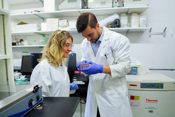Because Animals CEO, Dr. Shannon Falconer, examines animal cells with tissue scientist, Taylor Brooks, in the startup's lab.