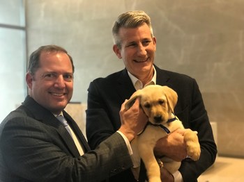 PenFed Credit Union CEO and President and PenFed Foundation CEO James Schenck and PenFed Foundation President John “Mick” Nicholson greet WestPoint, the newest member of the PenFed team from Canine Companions for Independence as he reports for his first day of duty.