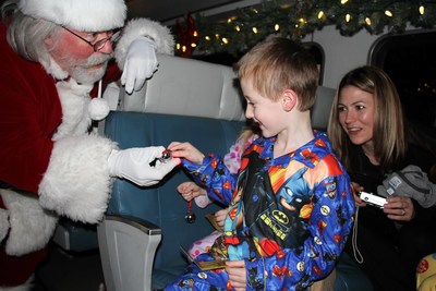 Santa greets each boy and girl on board. Santa greets each boy and girl on board.