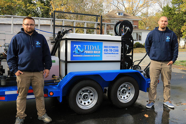 Tidal Power Wash team members with professional power washing equipment.