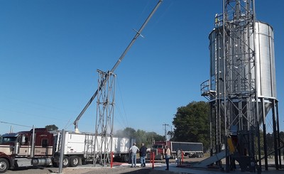 A hopper-bottom truck in Nebraska is loaded with ground GRAINZYME®  Phytase corn, in preparation for bulk delivery to poultry operations in North Carolina.