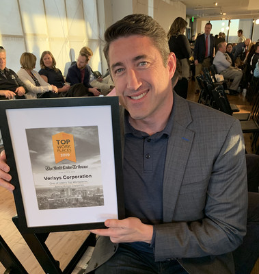 Verisys COO, Jamie Harper, accepts the 2019 Top Work Places award for Verisys.