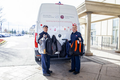 President of the Toronto Firefighters' Toy Drive Rick Berenz (L) joined his son, firefighter Geoff Berenz (R) to collect toys and load them into a Mercedes-Benz Sprinter Cargo van (CNW Group/Mercedes-Benz Canada Inc.)