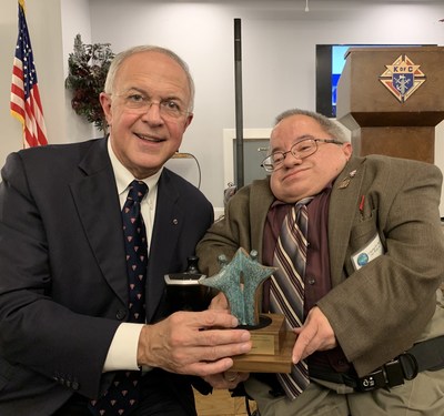 Michael Adamus, a board member of the National Catholic Partnership on Disability, presents an award by the NCPD to Knights of Columbus Supreme Knight Carl Anderson in recognition of the extensive work done by the Knights of Columbus on behalf of people with disabilities. Adamus is also the grand knight of K of C Holy Cross Council 12235 in Orlando, FL.