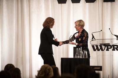 2018 WWPR Woman of the Year Award winner Wendy Hagen, President of hagen, inc, presents Maura Corbett, Chief Executive Officer and Founder, Glen Echo Group, with the 2019 WWPR Woman of the Year Award.