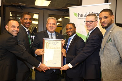 Yonkers Mayor Mike Spano presents Healthfirst with a Proclamation at the grand opening of the Healthfirst Community Office in Yonkers, NY. Pictured (L-R) Richard Pafundi, VP Retention and Customer Loyalty, Healthfirst; Roland Foster, AVP, Market Development, Healthfirst; Mayor Mike Spano; Errol Pierre, SVP, State Programs, Healthfirst; Paul Portsmore, SVP, Growth, Healthfirst; Anderson Perez, Manager, Market Development, Healthfirst