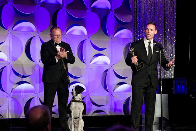 Randy Butcher with his service dog Ace and K9s for Warriors CEO Rory Diamond accept the Helping Heroes Award.