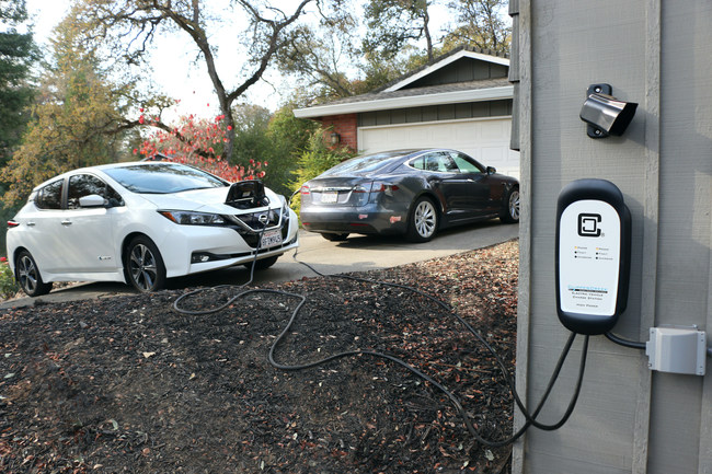 The HCS-D40P charging a Nissan Leaf and Tesla Model S. The dual charging station charges both vehicles simultaneously, automatically splitting power between them.