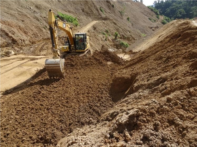 Excavator scarifying the Coffer dam surface prior to compaction. The surface was sealed with a smooth drum compactor due to impending rainfall. (CNW Group/TVI Pacific Inc.)