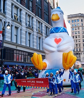 The Aflac Duck balloonicle is 30 feet tall and 15 feet wide.  His glowing heart is encased by his heart-shaped wings, and his inner-tube base used to “slide” down the parade route is larger than the size of an in-ground home swimming pool.