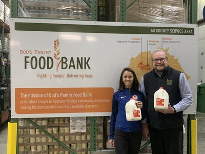 Lee Kiefer (left) a U.S. Olympic fencer and Lexington native, donates a year’s worth of milk to God’s Pantry Food Bank. Michael Halligan, food bank CEO was on hand to help accept the donation.