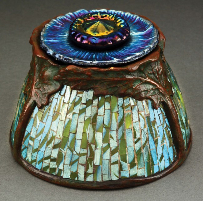 Extremely rare and important Tiffany Studios 'Poppy' inkwell, designed by Clara Driscoll, bronze and Favrile glass, impressed 'TIFFANY STUDIOS NEW YORK 867,' engraved signature 'L.C. TIFFANY FAVRILE.' Estimate $40,000-$60,000