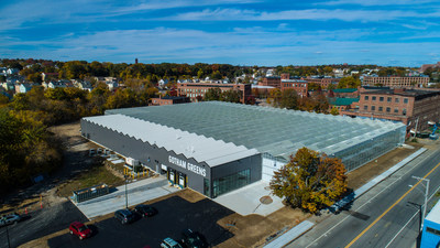 The new 100,000 square foot, high-tech urban greenhouse is Gotham Greens' first greenhouse in New England and seventh greenhouse nationwide. Gotham Greens delivers consumers a year-round supply of fresh produce to retail, restaurant and foodservice customers across the New England region. (Photo credit: Gotham Greens and Off The Ground Drone Services)