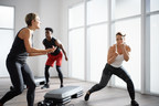 An instructor leads two people through Life Time's Ringside group fitness class
