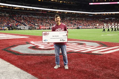 Tyler Gordon wins $100,000 in tuition after competing in the Dr Pepper Tuition Giveaway during halftime of the Big Ten Conference Championship (Photo Credit: Dr Pepper)