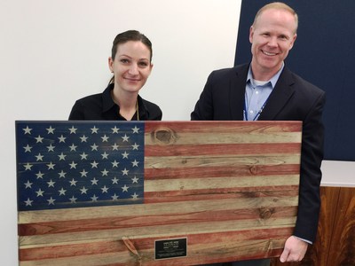 Miranda Jones, PenFed Military and College Recruitment Lead and Charlie Miles, PenFed Military Employment Programs Director, hold the Northern Virginia Technology Council Foundation's Veterans Employment Initiative Veteran Service Award from Flags of Valor