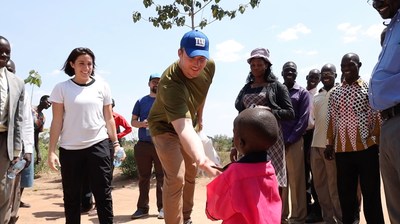 Nate Solder greets a child in Uganda.
