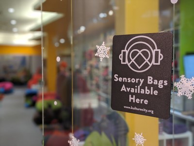 KultureCity's sensory badge on Yogibo' s store at the Pheasant Lane Mall in Nashua, NH. This sign lets families know sensory bags are available here, as well as through the KultureCity app