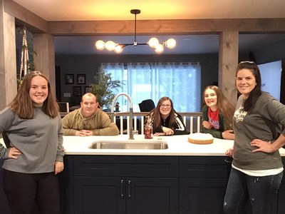 Wojcik family in their new kitchen with Caesarstone countertops.