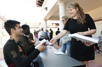 Danny Soto, a student at Olympic Heights Community High School in Boca Raton, Florida, signs a copy of Show, Don’t Tell for Andrea Shue, Canon Solutions America’s Segment Specialist, during the Future Authors Project event at Spanish River Library.